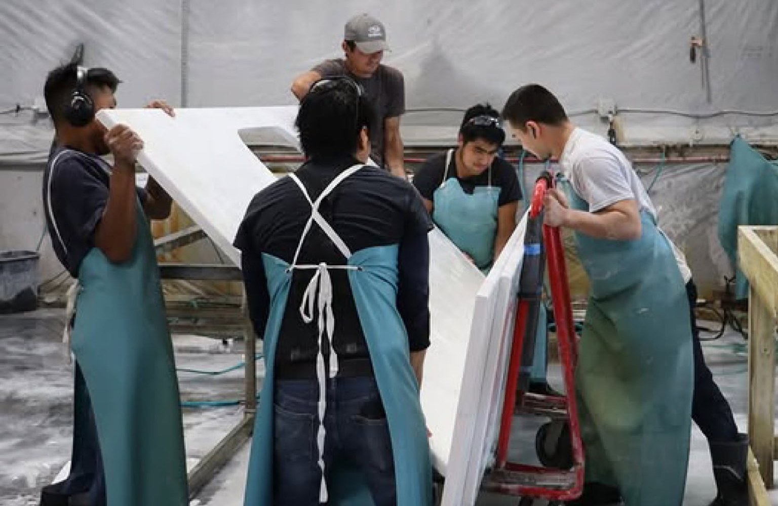 The Absolute Stone Design TN crew moving a white quartz countertop in our Chattanooga fabrication shop